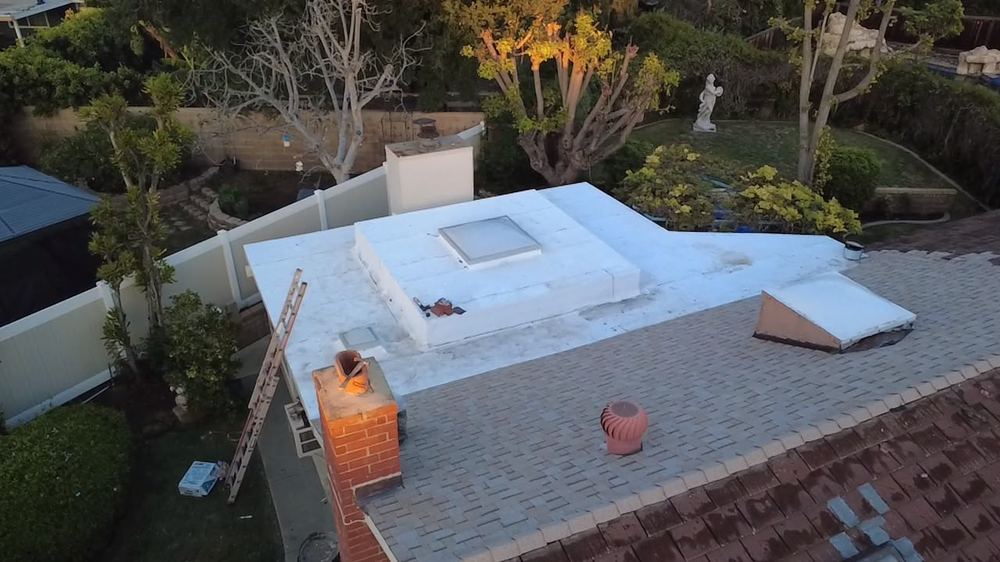 White flat roof system with skylight, aerial view